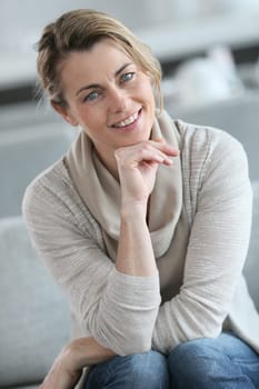 Portrait of smiling mature woman with hand on chin
