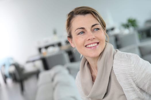 Portrait of middle-aged blond woman at home