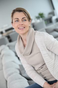 Portrait of middle-aged blond woman at home