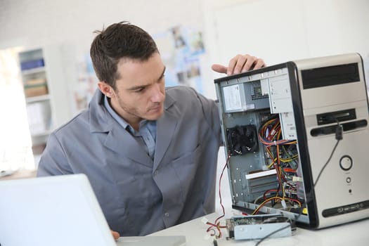 Technician fixing computer hardware