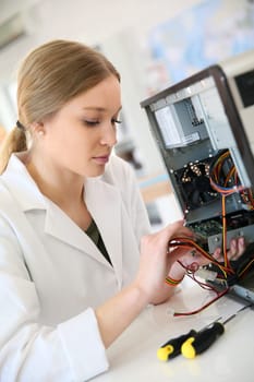 Student girl in technology fixug computer hard drive