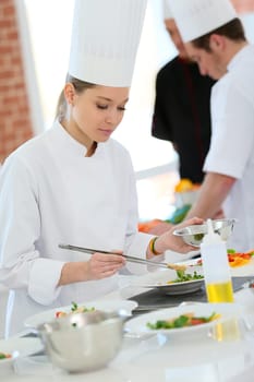 Girl in cooking training class preparing dish