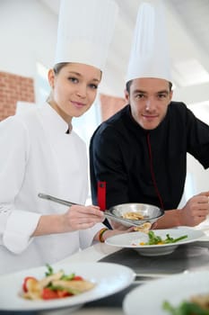 Girl in cooking training class with chef