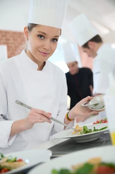 Girl in cooking training class preparing dish