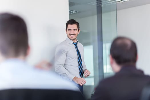 Relaxed cheerful team leader and business owner leading informal in-house business meeting. Business and entrepreneurship concept.
