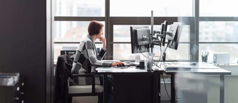 Confident independent business woman working in corporate office. Female equality in business and entrepreneurship concept.