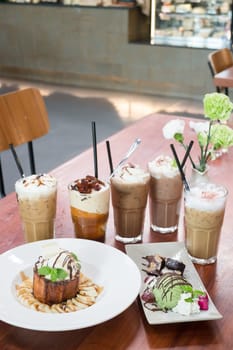 Variety iced coffee drinks on wooden table, stock photo