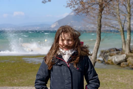 a preteen girl with hair in the wind