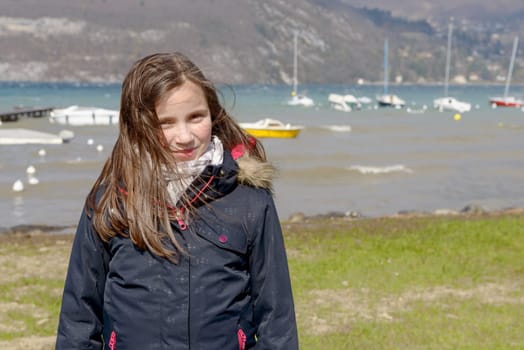 a preteen girl with hair in the wind