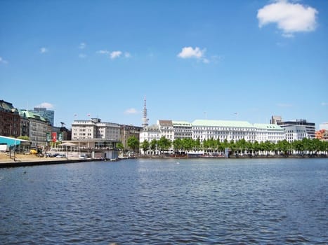 Hamburg, Germany - May 22, 2008: Lake Binnenalster with the new Jungfernstieg. Cafe Alex Hamburg, Alsterpavillion (left), broadcasting tower and hotel Vier Jahreszeiten (right)