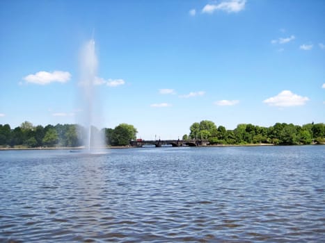 Lake Alster Hamburg, Germany with fountain and bridge in the background - view from pier of Binnenalster near Jungfernstieg