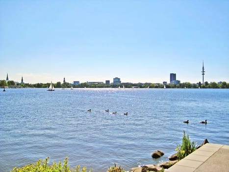 Hamburg lake Aussenalster with sailing boats - skyline of Hamburg city