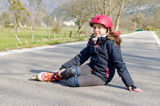 young attractive teenage skater grimacing in pain after taking a fall
