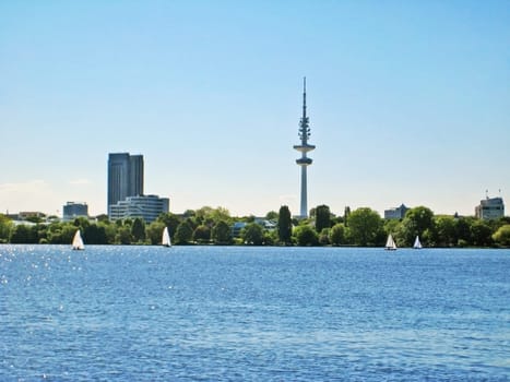 Hamburg lake Aussenalster with sailing boats - skyline of Hamburg city