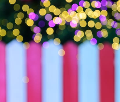 Blur image background of red and white striped wall with Christmas bokeh lights