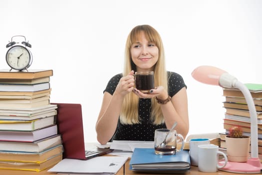 Student enjoys a glass of coffee at night preparing for exams