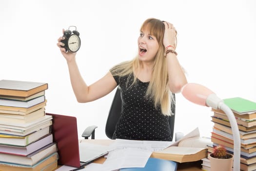 A student with an alarm clock in hands understand that slept exam and screaming looking at his watch