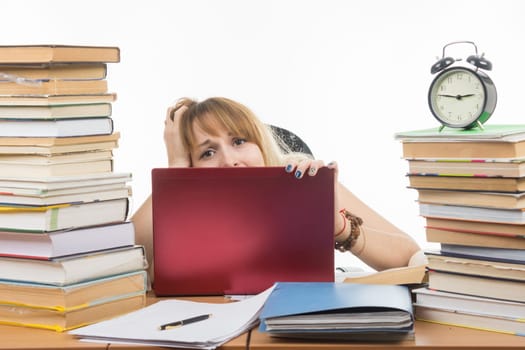 Student horrified looks from behind the laptop