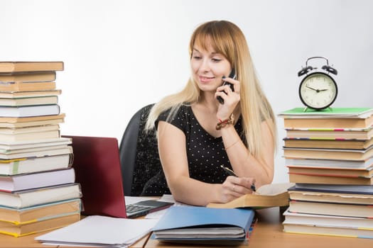 A student preparing for exams and talking on the phone