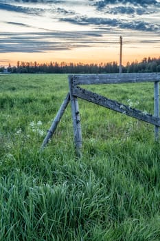 Wooden Fence in Field at sunrise.