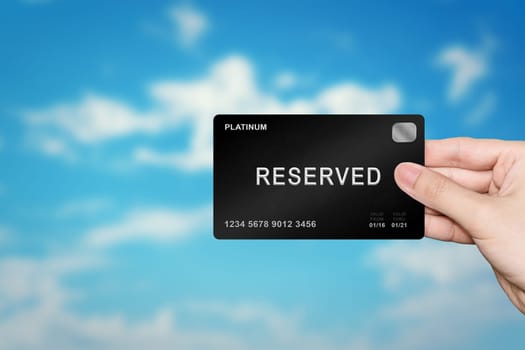 hand picking reserved platinum card on blur background