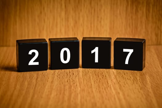 Happy new year 2017 text on black block