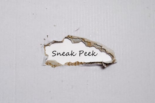 The word sneak peek appearing behind torn paper.