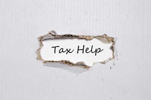 The word tax help appearing behind torn paper.