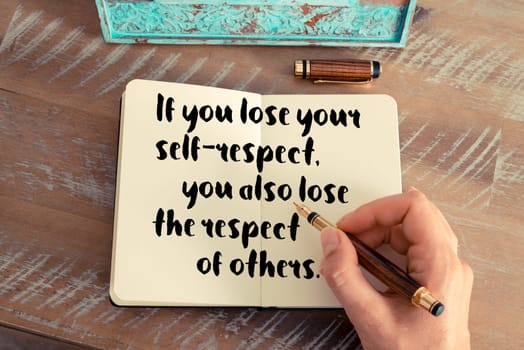 Retro effect and toned image of a woman hand writing on a notebook. Handwritten quote If you lose your self-respect, you also lose the respect of others as inspirational concept image