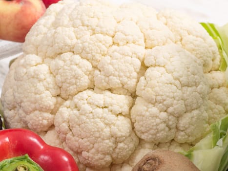 a cauliflower and some fresh vegetables