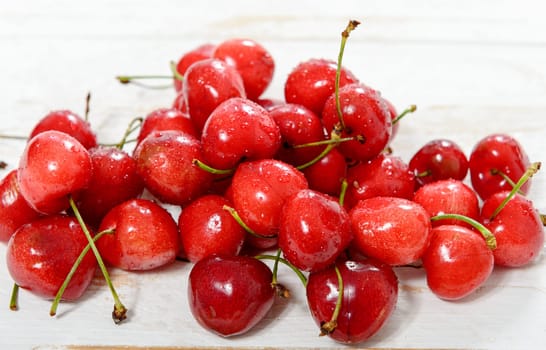 fresh cherries on white wooden table