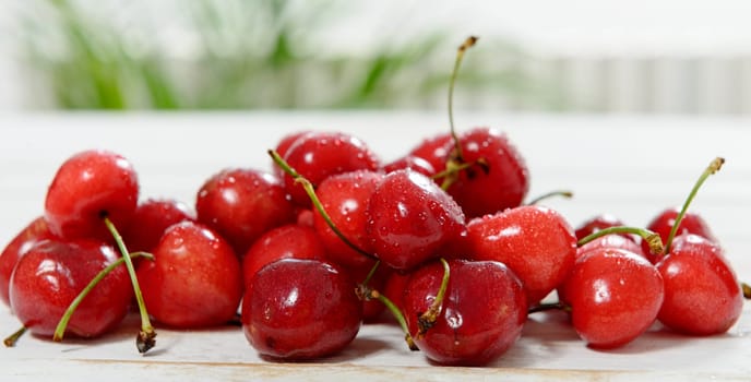 fresh cherries on white wooden table
