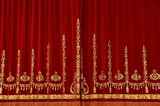 Theatrical red velvet curtain with gold pattern
