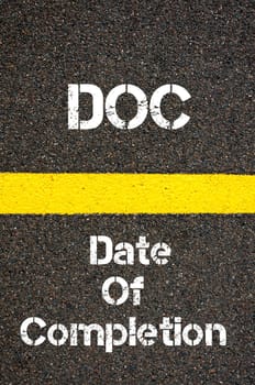Concept image of Business Acronym DOC Date Of Completion written over road marking yellow paint line