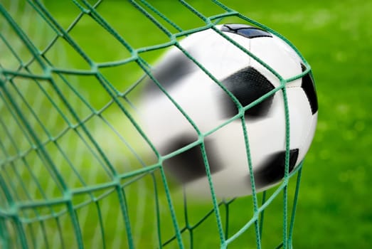 Football or soccer goal,with the ball leaving a trail in the air as a dynamic motion blur effect