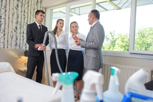 Hotel cleaning team talking to supervisor