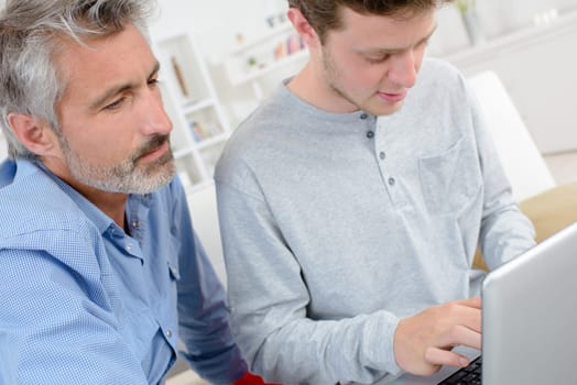 men in the house with laptop