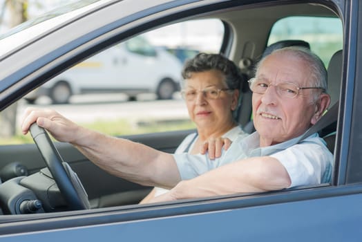 elderly couple in the car