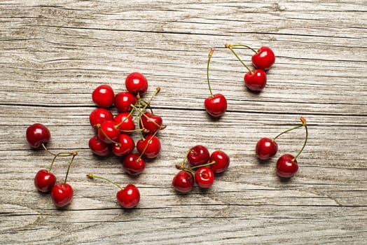 Fresh cherries on wooden table close up.
