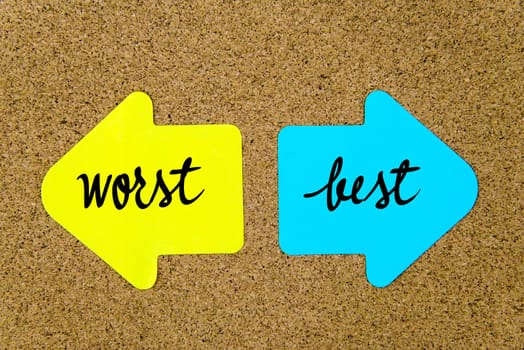 Message Worst versus Best on yellow and blue paper notes as opposite arrows pinned on cork board with thumbtacks. Choice conceptual image