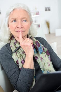 Pensive senior  with a notepad