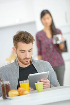 Checking his e-mails during breakfast