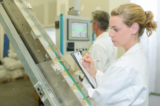 Lady auditing in factory