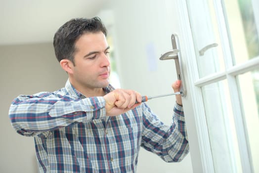 Man changing a door handle