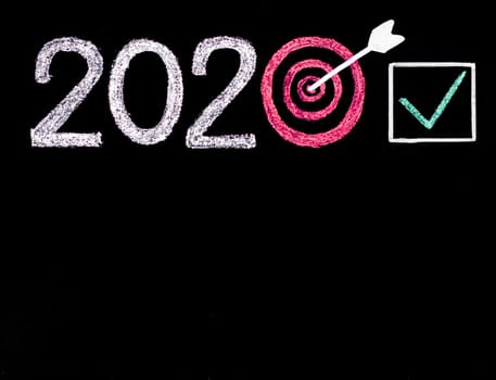 Conceptual image of Year 2020, with number zero in shape of a target, arrow in the center and checked sign