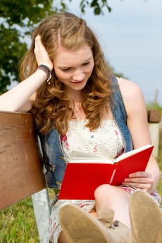 Young woman with book in nature