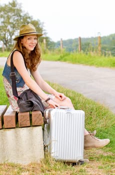 Girl with suitcase waiting for departure