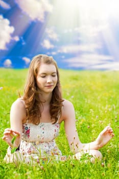 Young woman meditating in nature