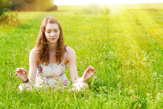 Young woman meditating in nature