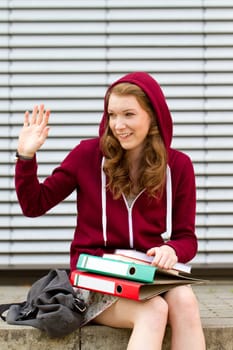 Schoolgirl in the pausenhof waves to her friend